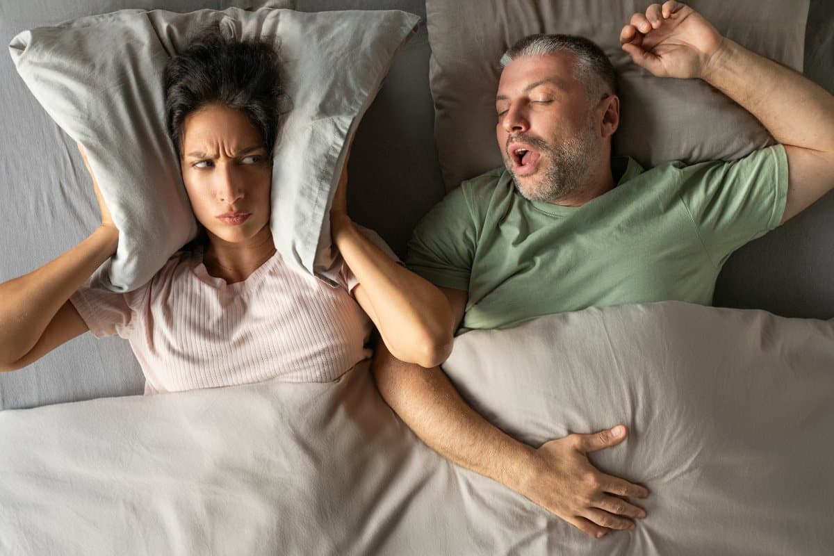 A woman irritated by the guy snoring beside her