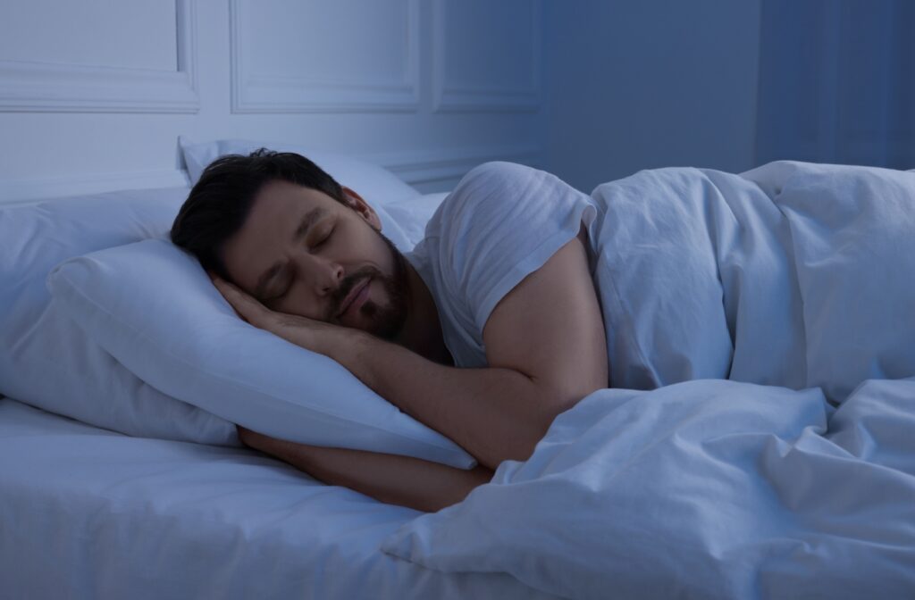 A person sleeping with a sleep apnea oral appliance.